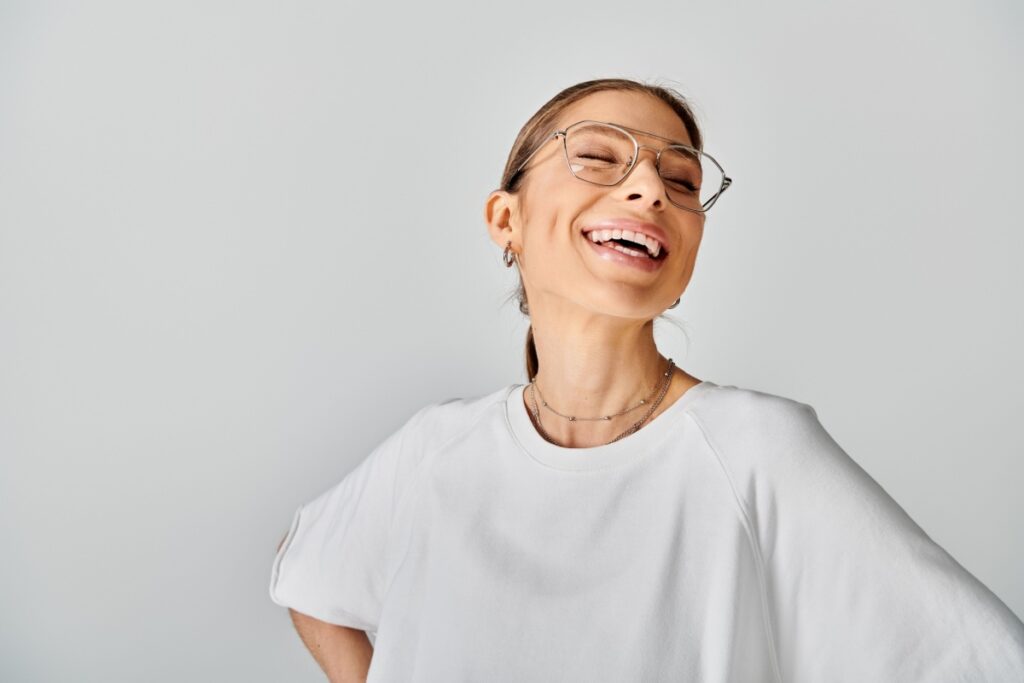 Happy young woman wearing glasses.